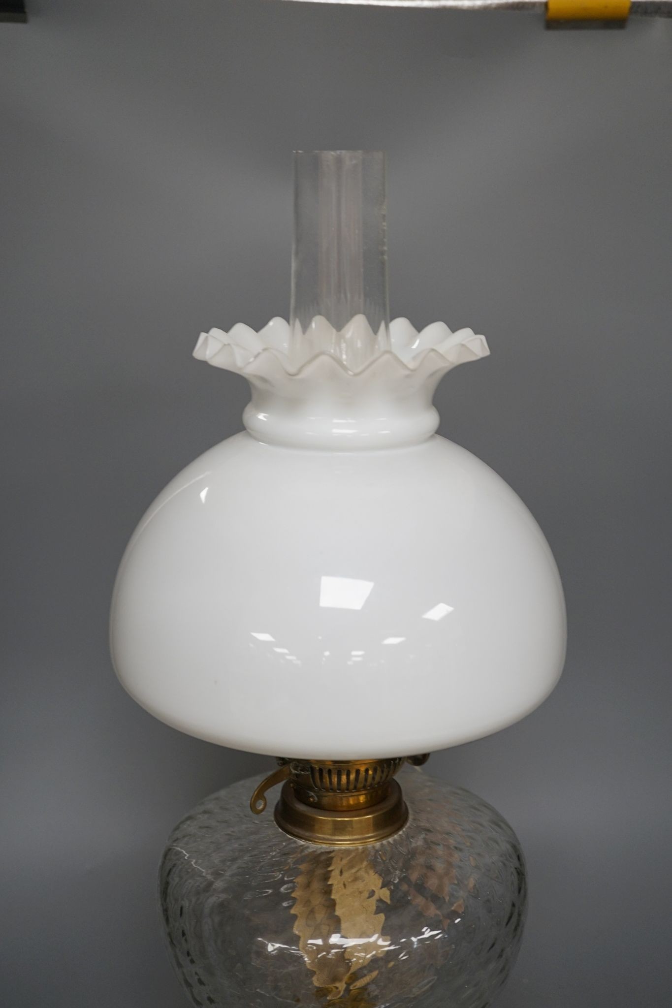 A brass oil lamp with opaque shade 60cm total height